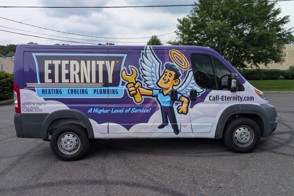 Colorful Eternity service van for heating, cooling, plumbing with angel graphic and contact info on the side.