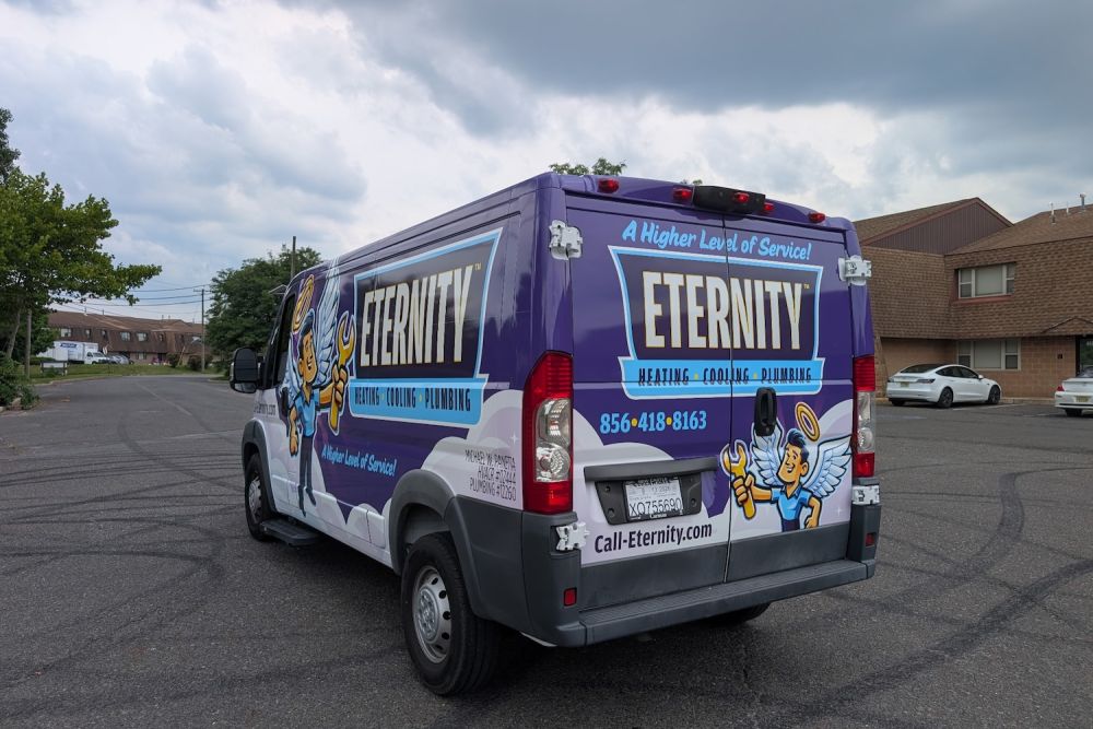 Eternity Heating, Cooling & Plumbing service van on a cloudy day in a residential area. Phone: 856-418-8163.